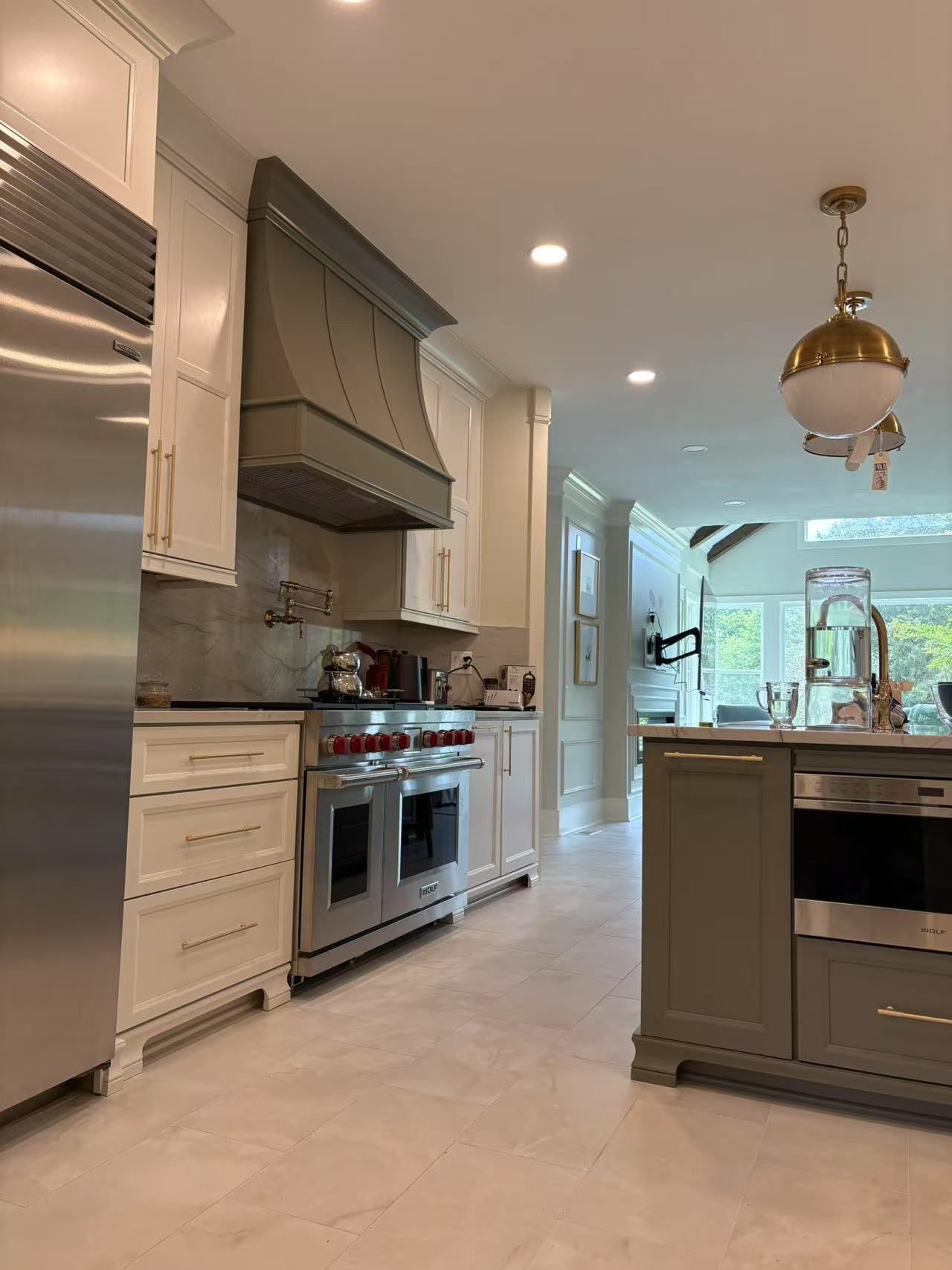 A kitchen with stainless steel appliances and white cabinets.