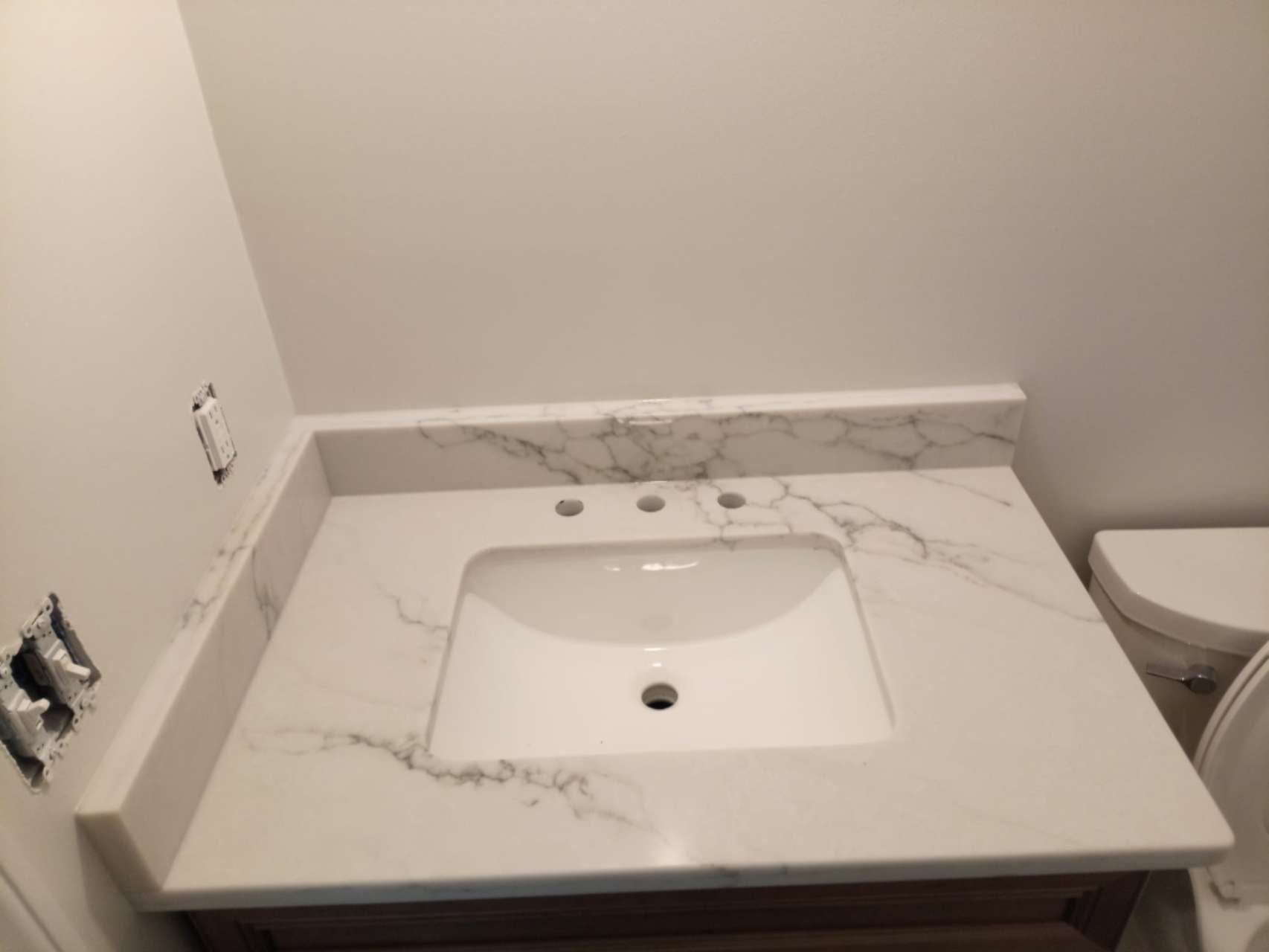 A bathroom with a sink and toilet in it.