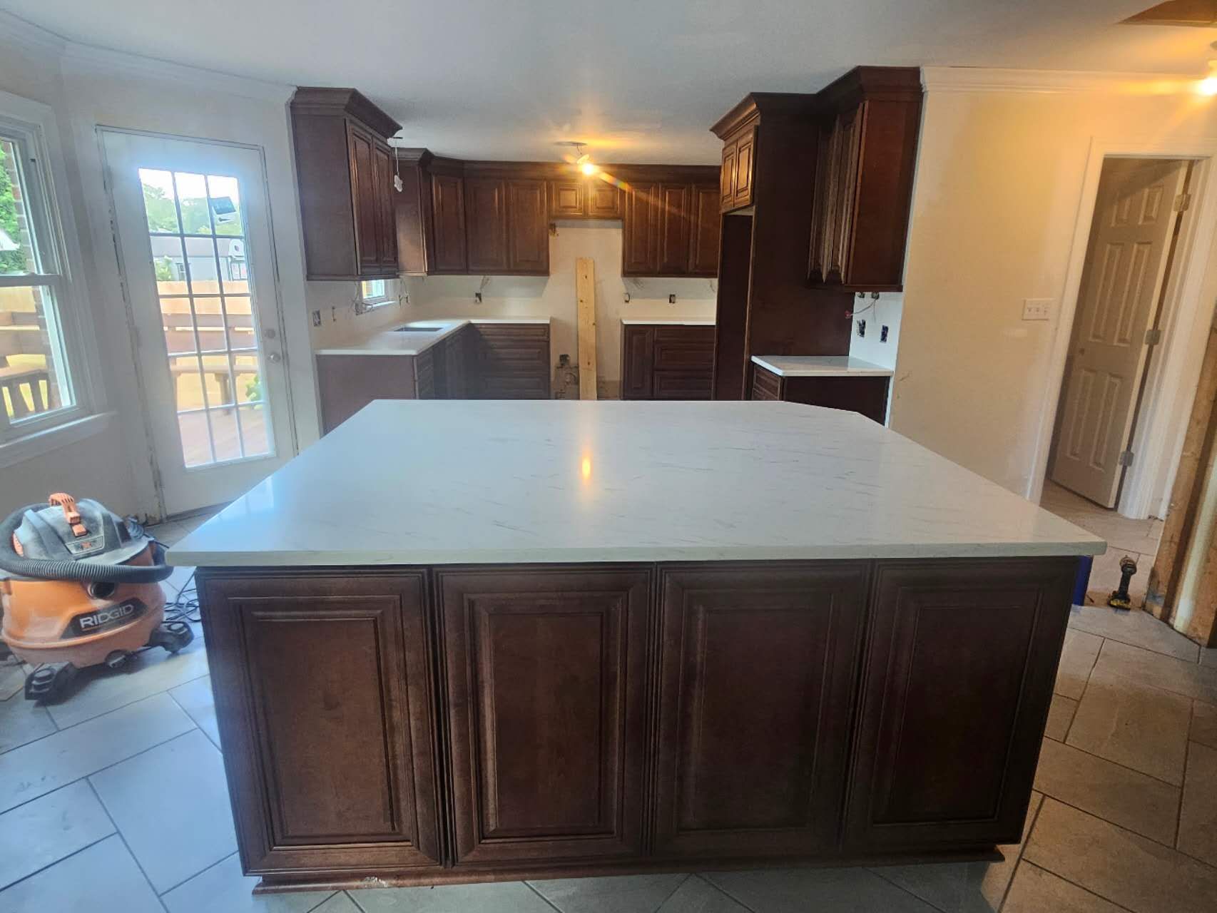 A kitchen with a large island in the middle of it.