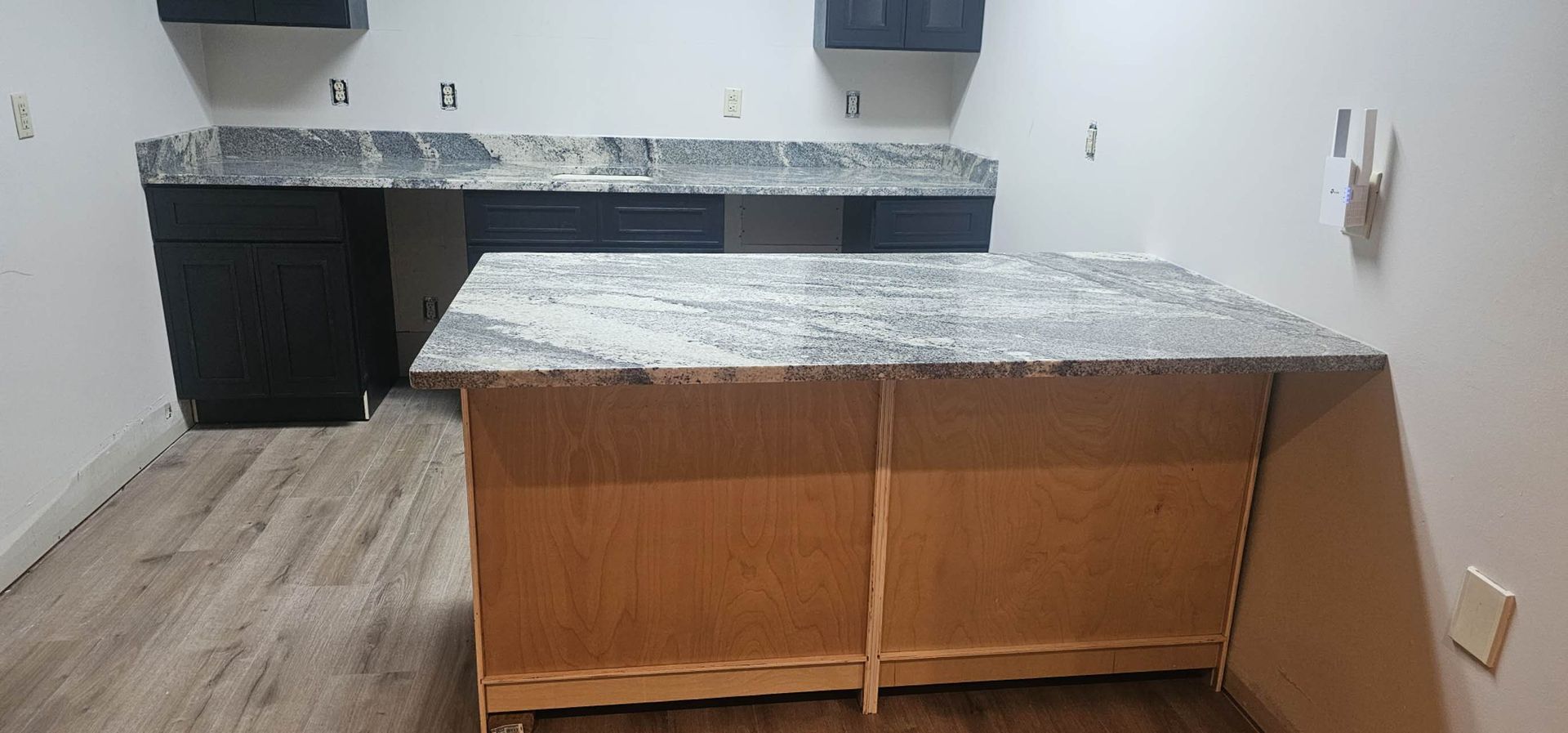 A kitchen with a large island in the middle of the room.