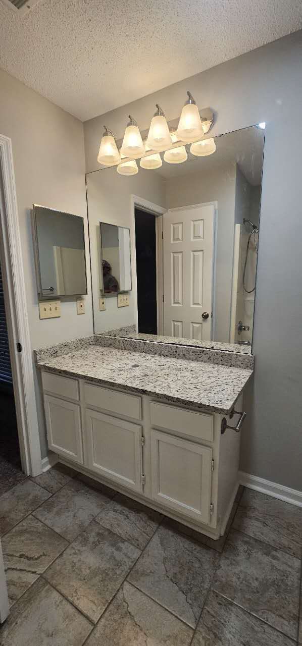 A bathroom with two sinks and a large mirror.