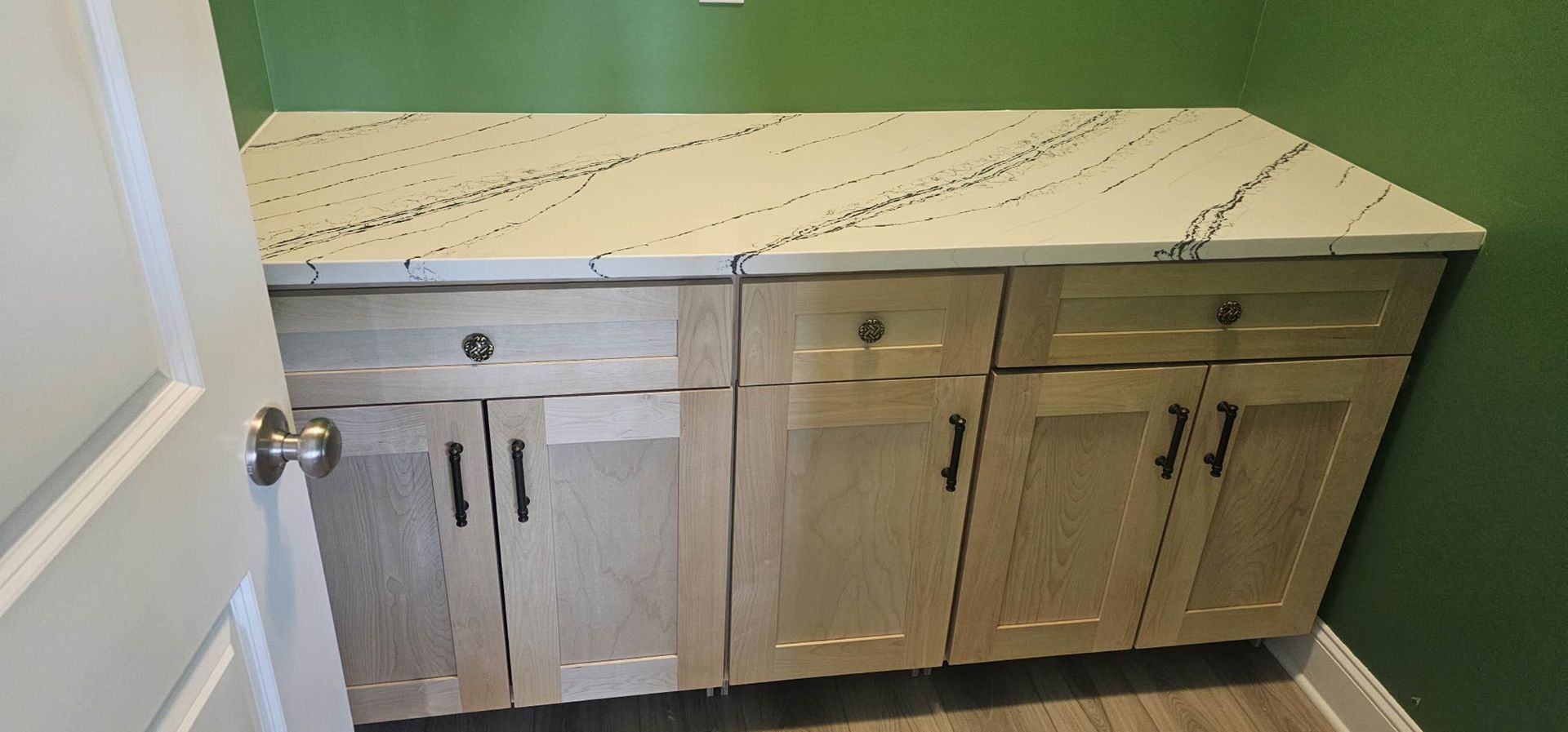 A kitchen with wooden cabinets and a white counter top.