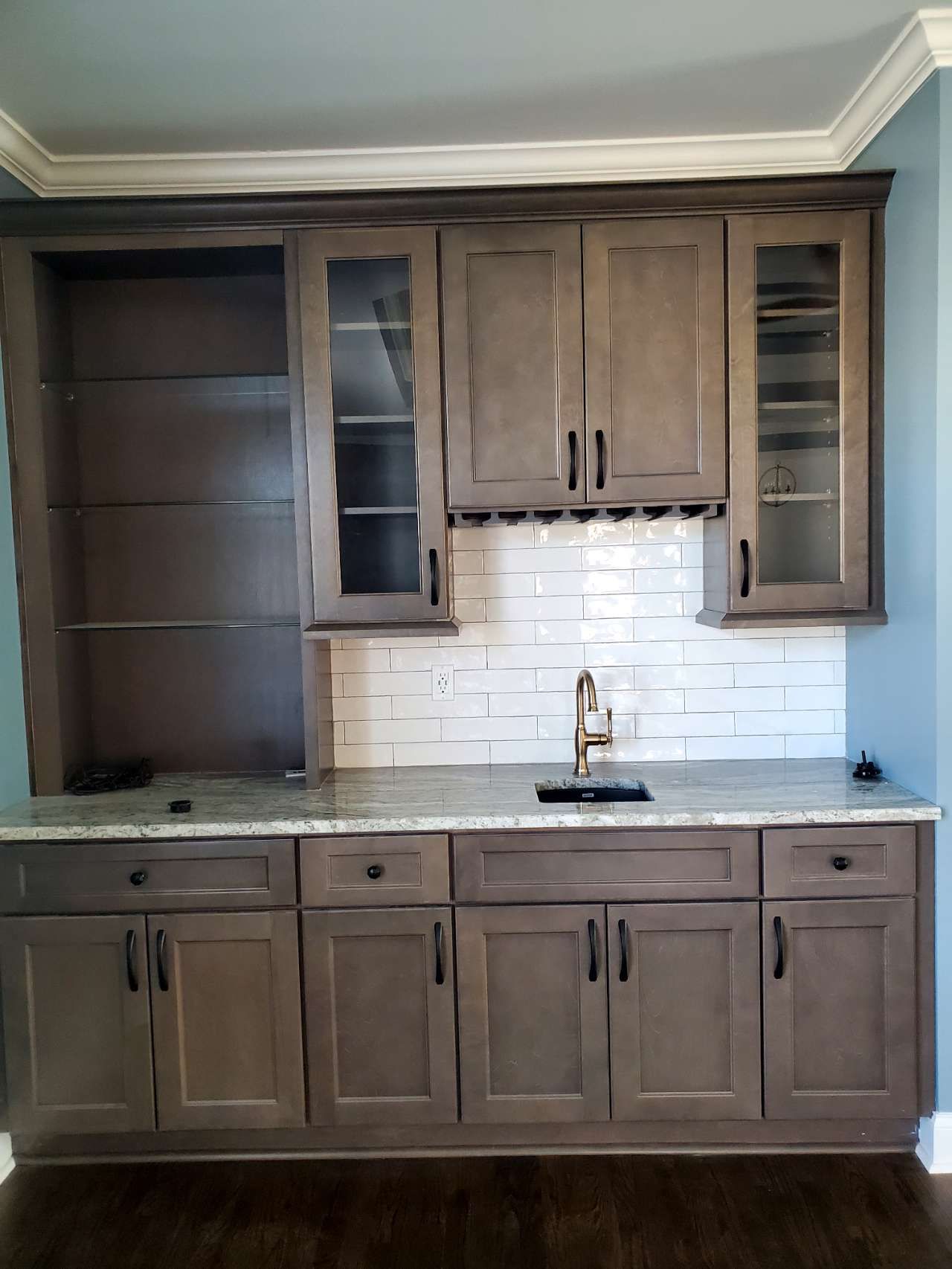A kitchen with lots of cabinets and a sink.