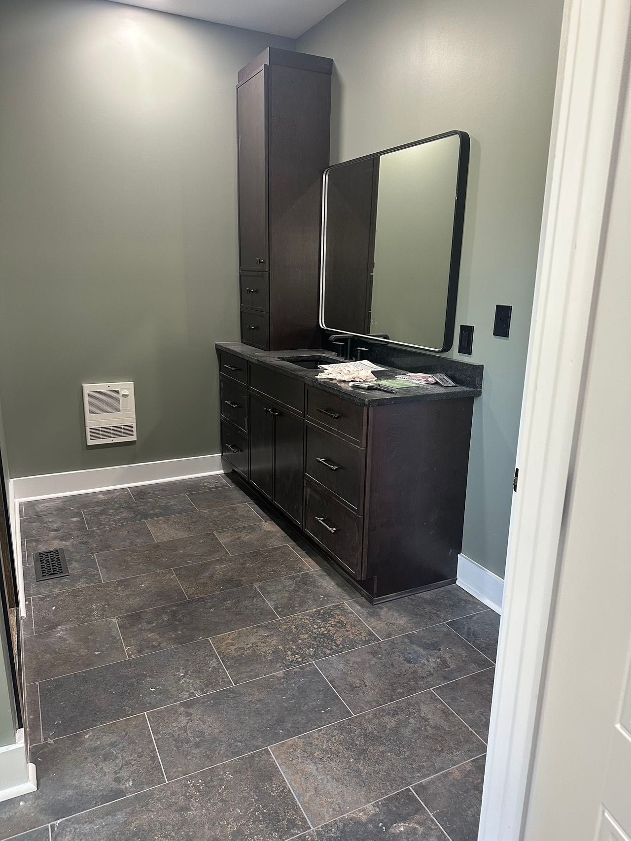A bathroom with two sinks and a mirror.