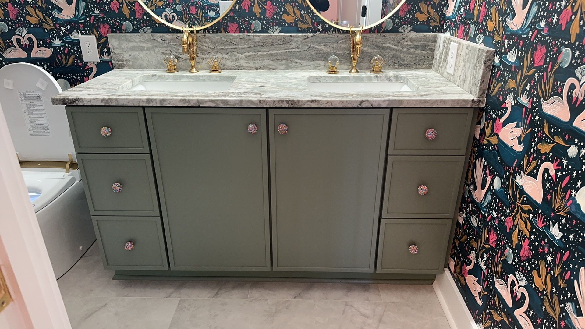 A bathroom with two sinks, two mirrors, and a toilet.