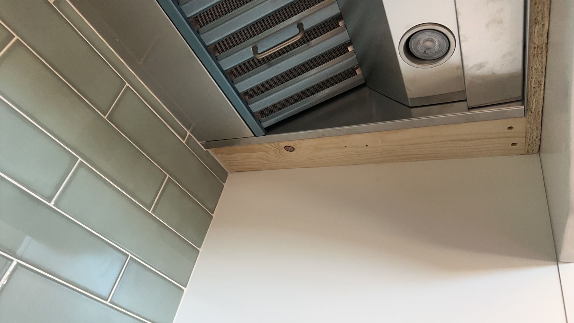 A ceiling fan is being installed in a kitchen.