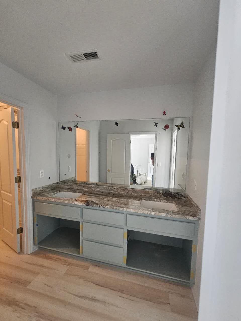 A bathroom with two sinks and a large mirror.