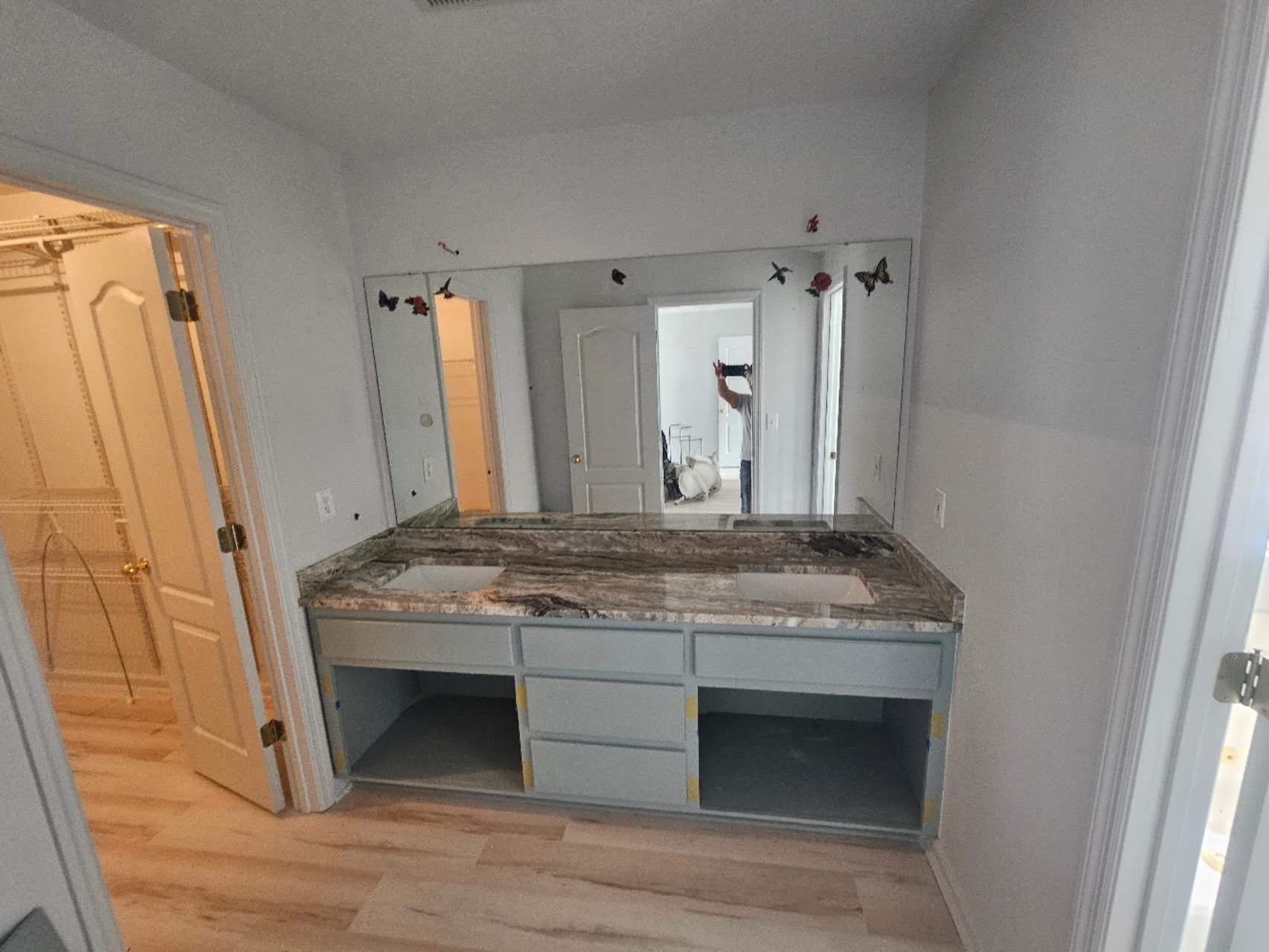 A bathroom with two sinks and a large mirror.