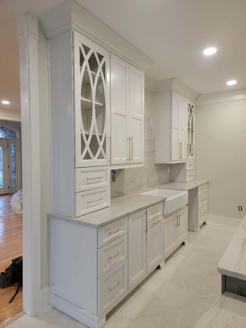 A kitchen with white cabinets and a sink.