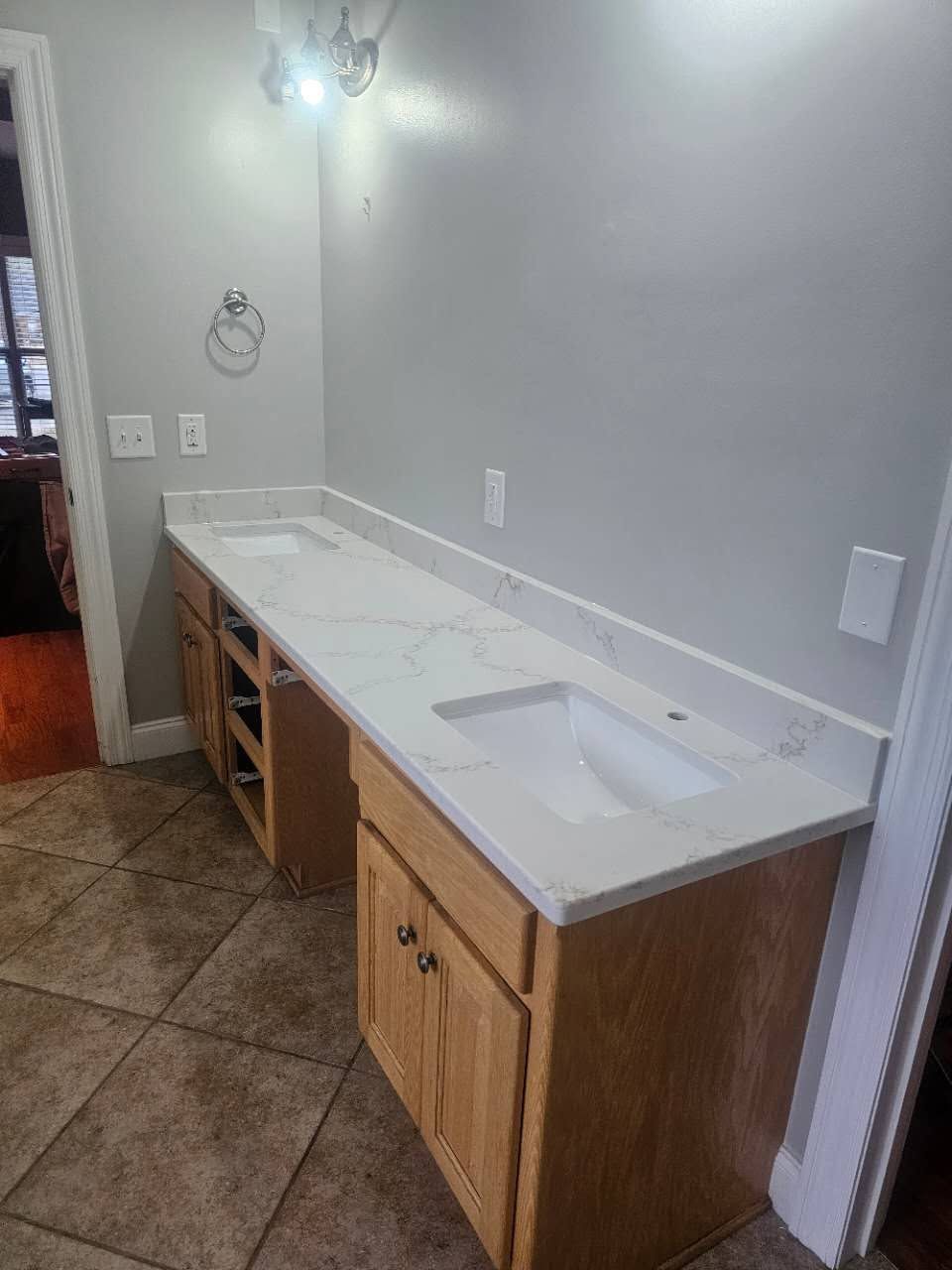 A bathroom with two sinks and a long counter top.