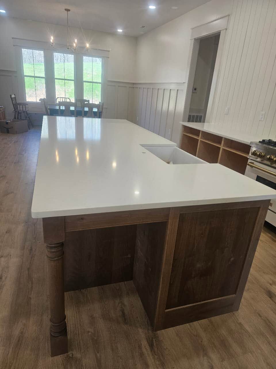 A kitchen with a large island and a sink.