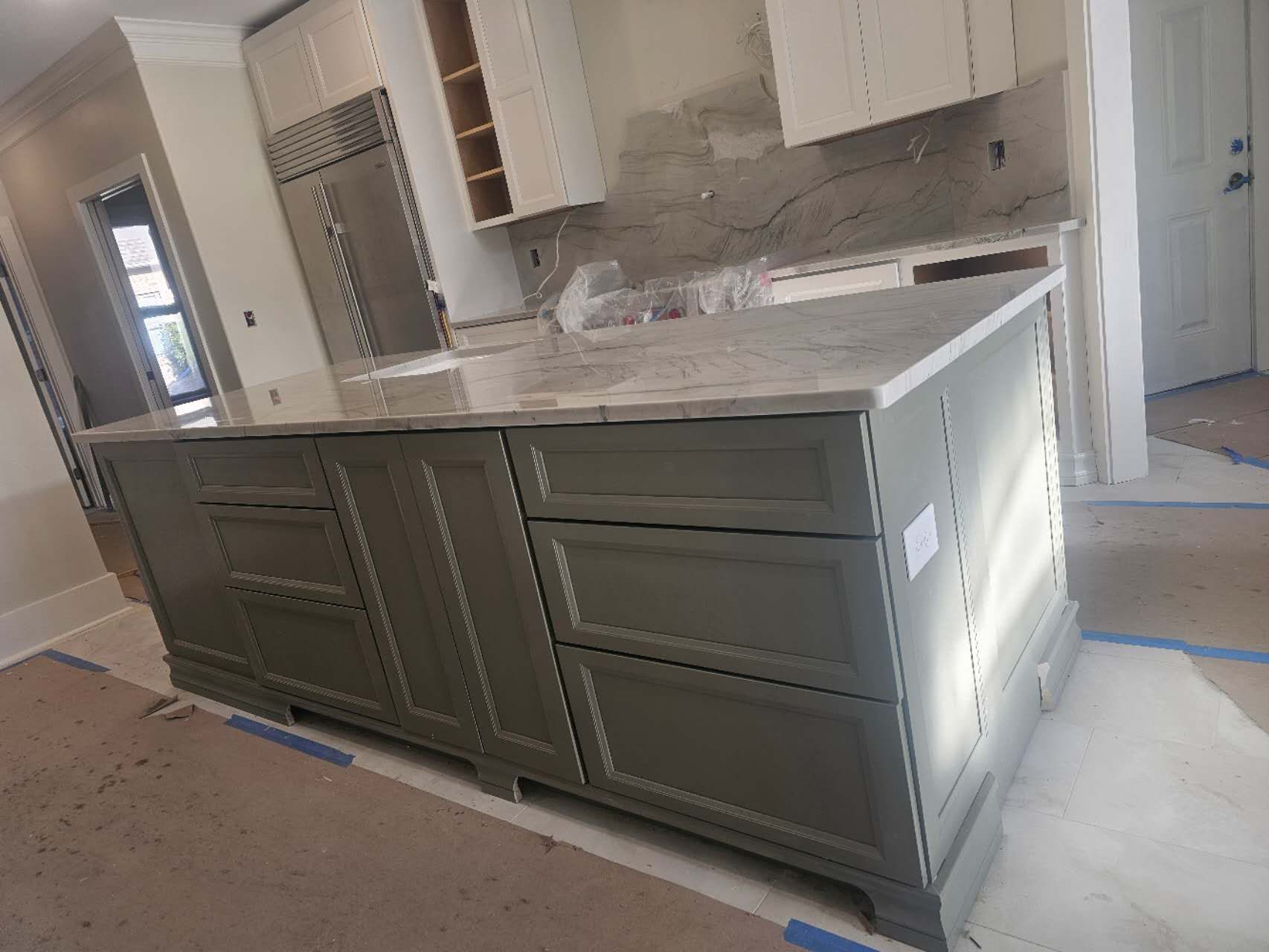 A kitchen with a large island in the middle of it.