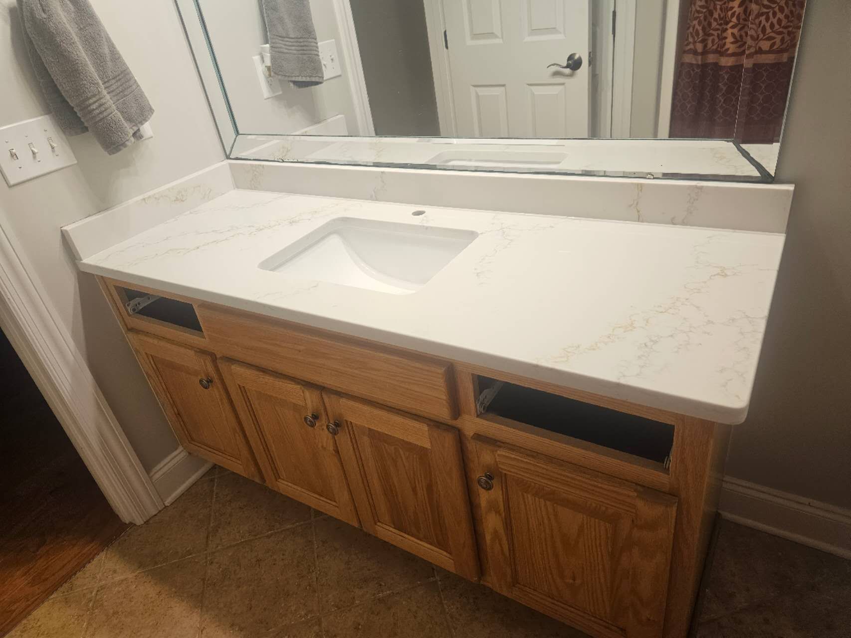 A bathroom vanity with a sink and a mirror.