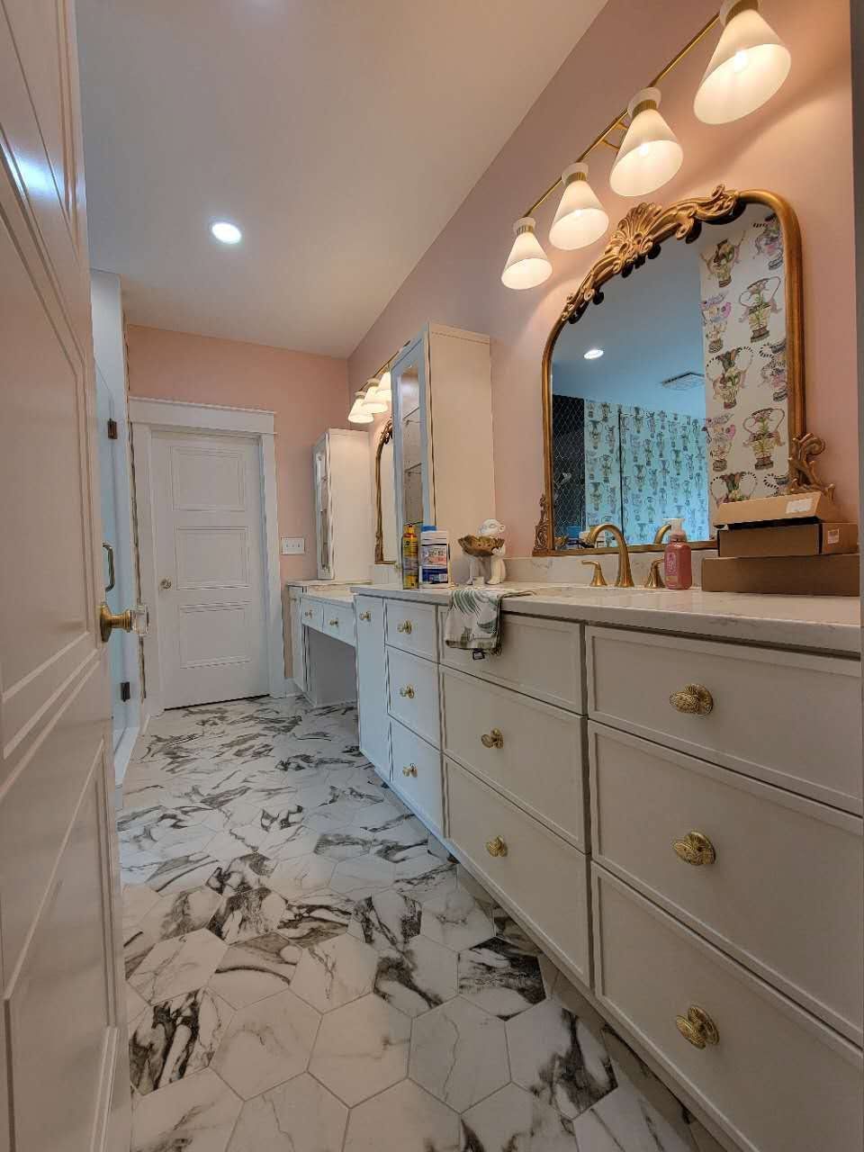 A bathroom with two sinks, a mirror, and a marble floor.