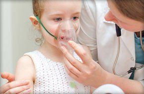 Little girl wearing oxygen mask
