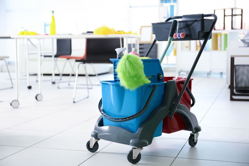a cleaning cart with two buckets and a mop in an office
