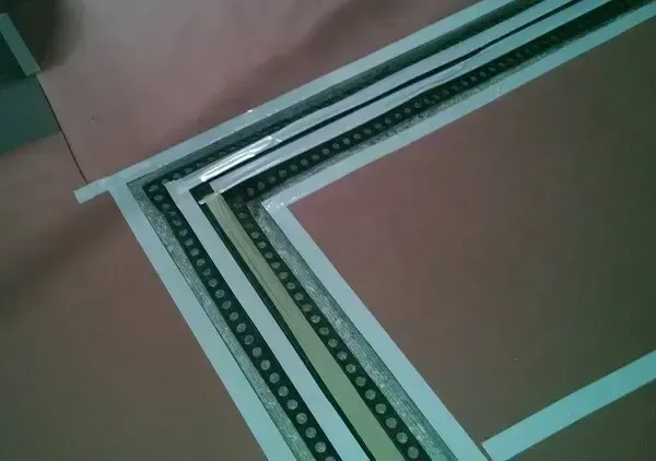 Paper with layered strips of black and white tape, creating angled borders.