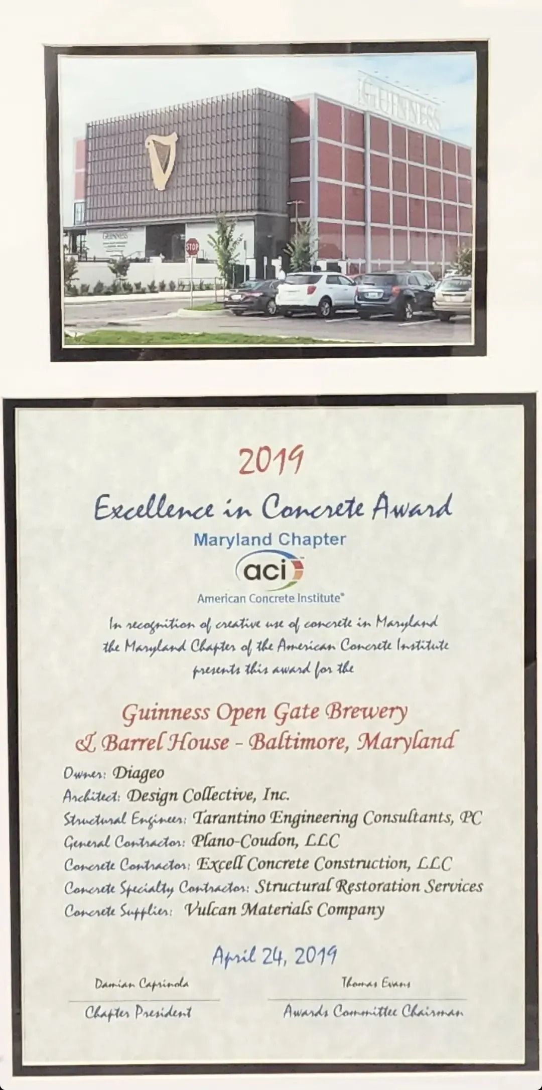 Photograph of a building, framed by a certificate for the 