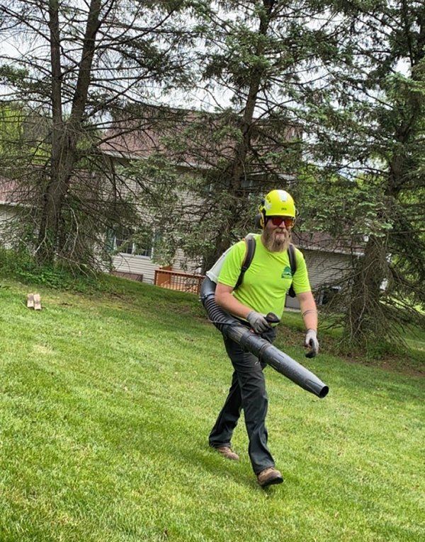 Man carrying backpack blower