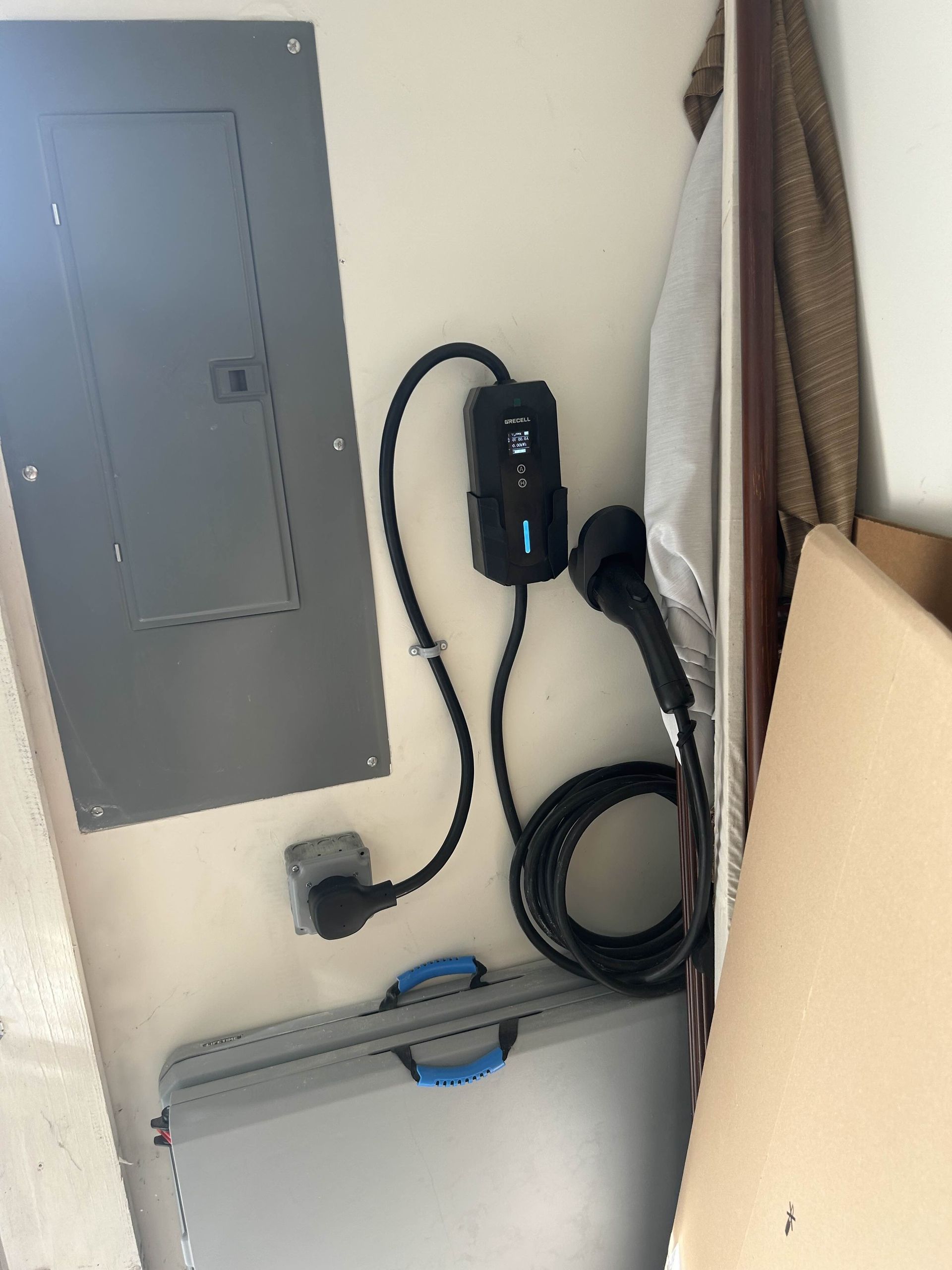 Modern white kitchen with island, range hood, and black pendant lights.