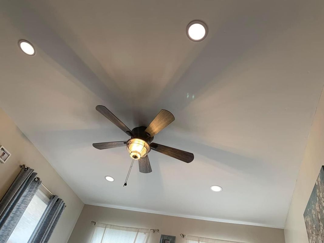 Ceiling with recessed lights and a ceiling fan.