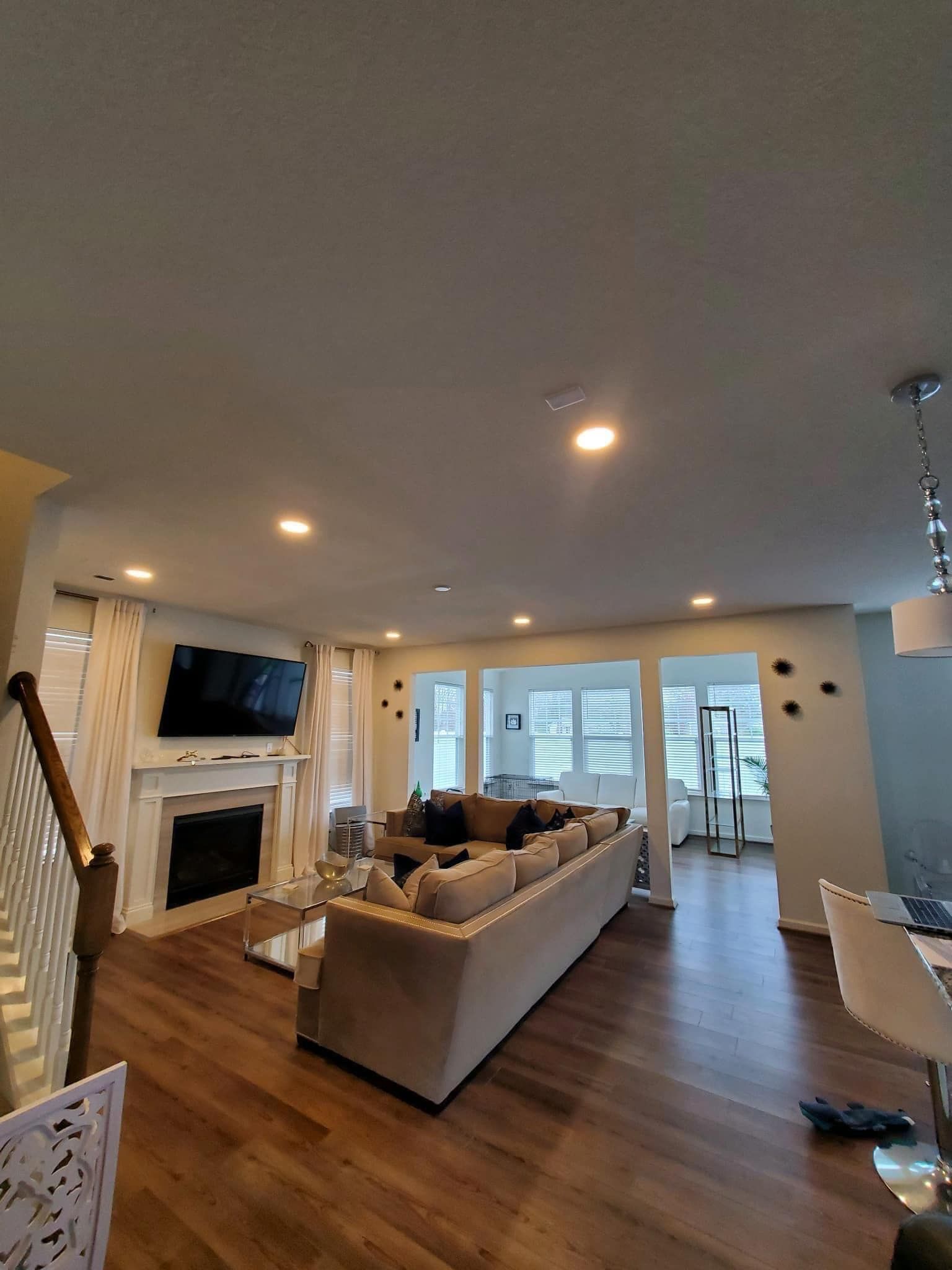 Living room with a fireplace, TV, and large sectional sofa.