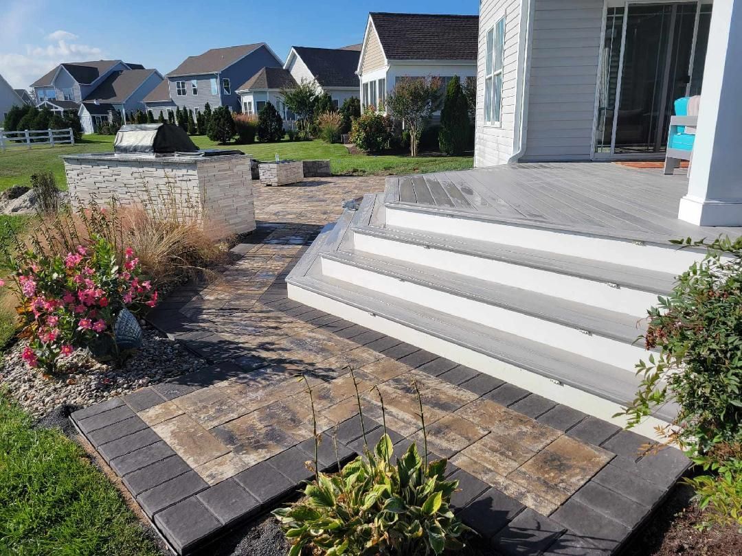A patio with stairs leading up to a house in a residential area.