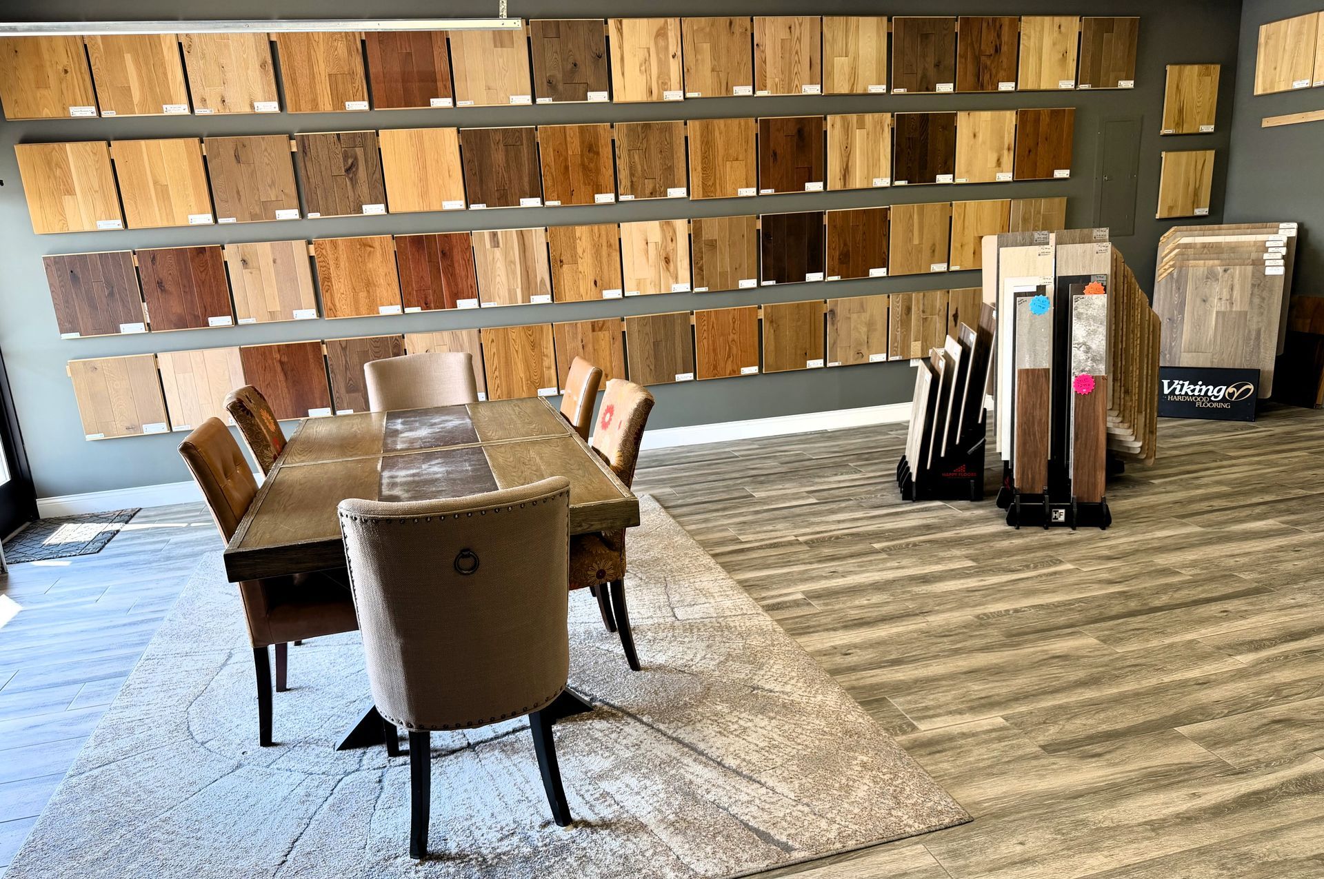 Restaurant dining area with wooden tables, chairs, and shelves against a wood-paneled wall
