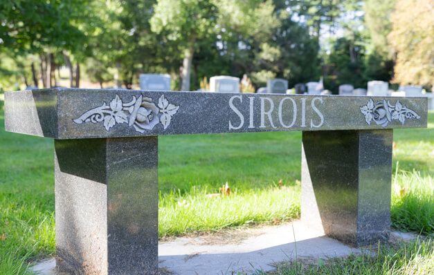 A stone bench in a cemetery