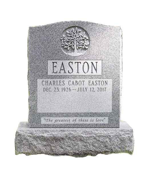 A gravestone with a tree design