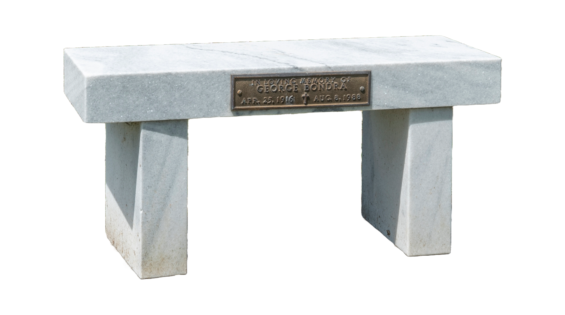 A white marble bench with a plaque on it