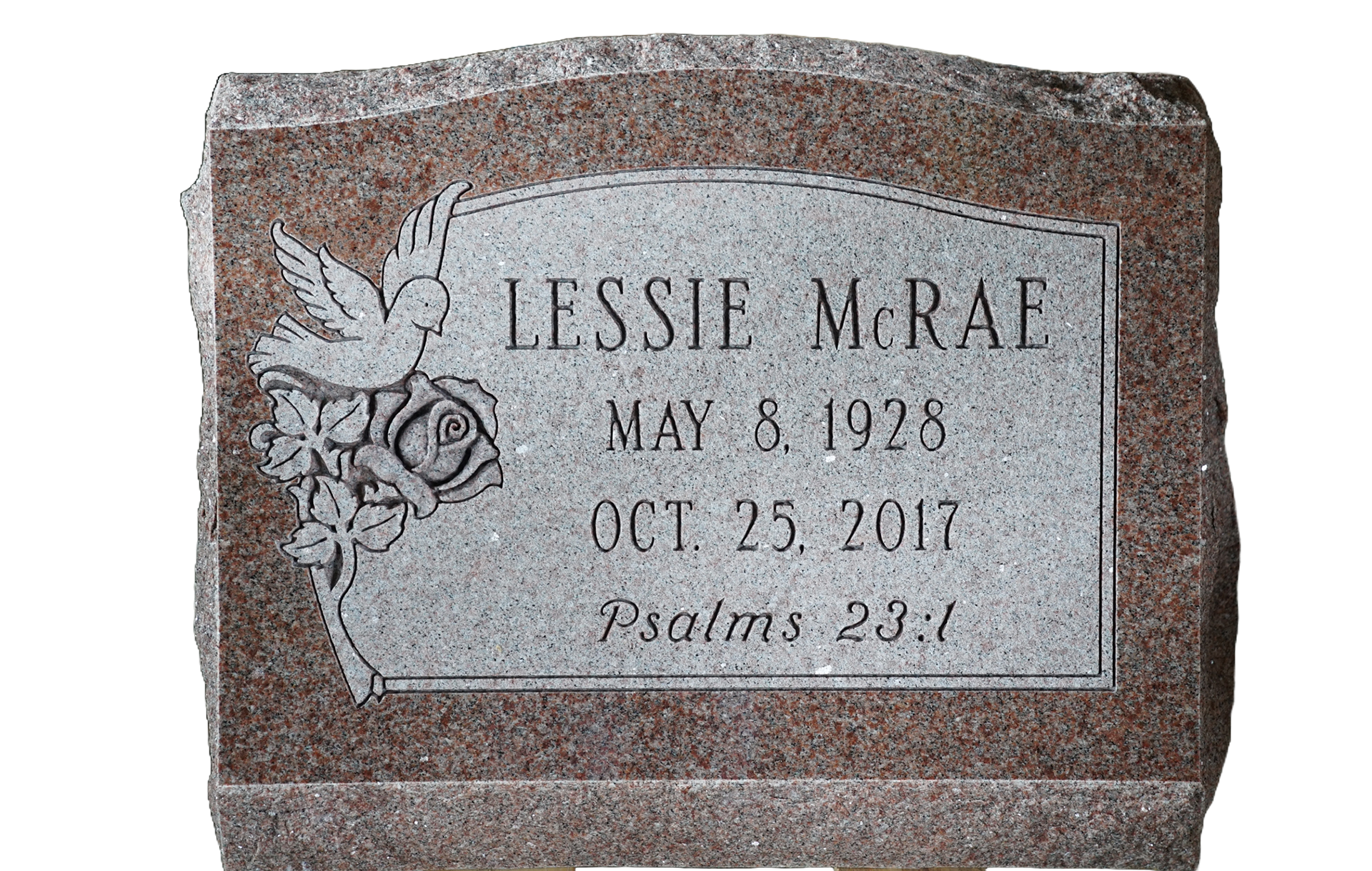 A gravestone for lessie mcral is sitting on a wooden stand.