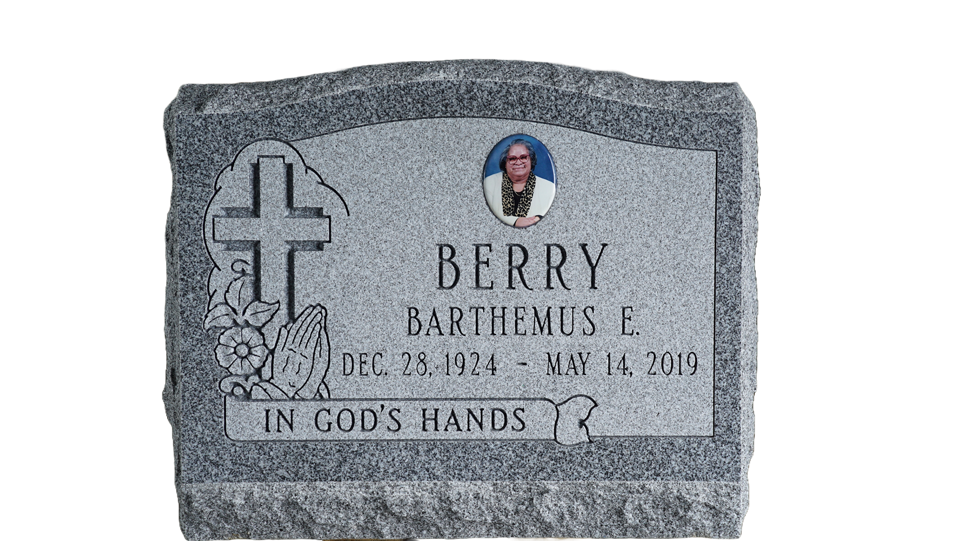 A gravestone with a picture of a man and a cross on it.