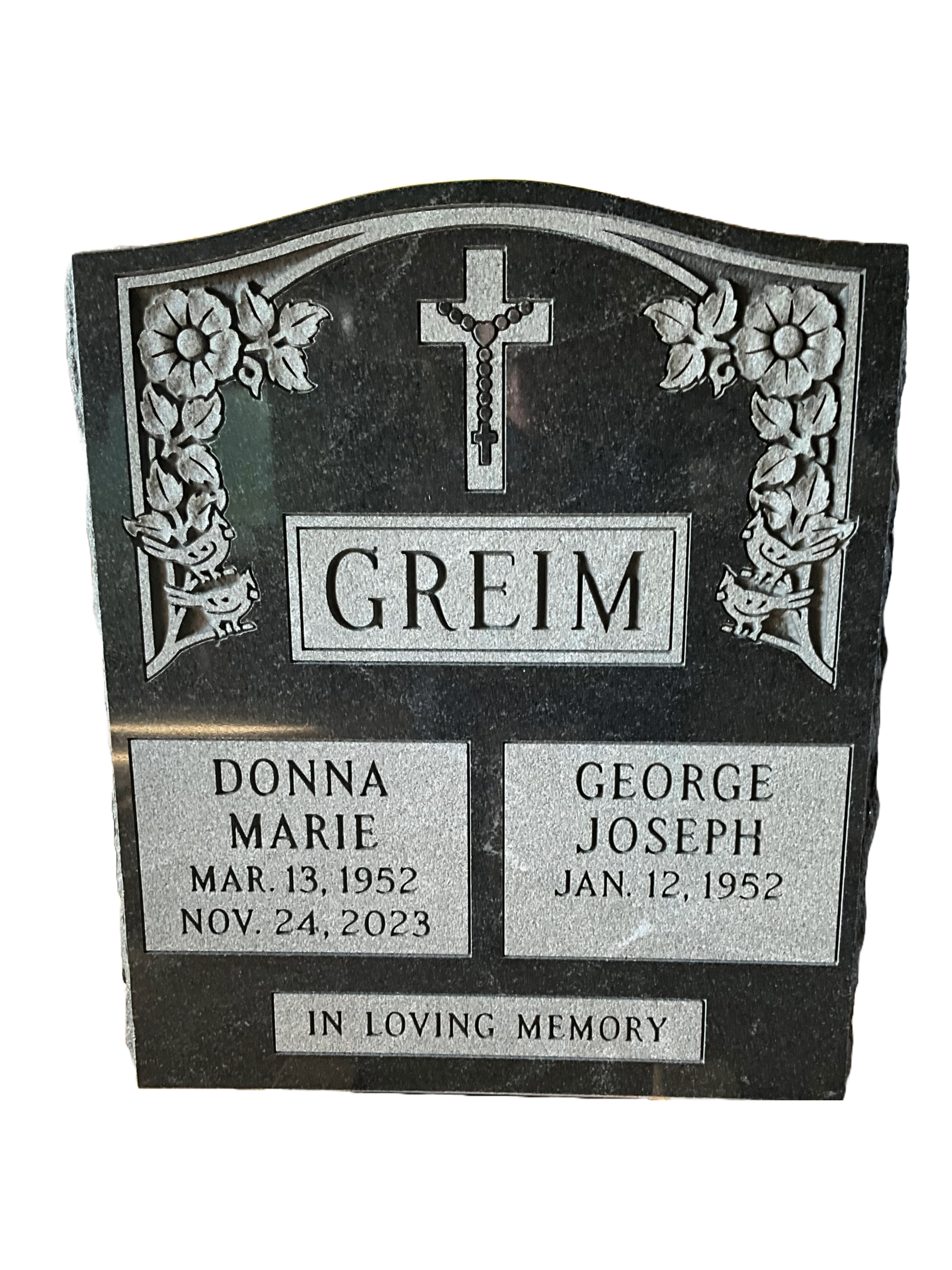 A gravestone for a couple of people with a cross on it.