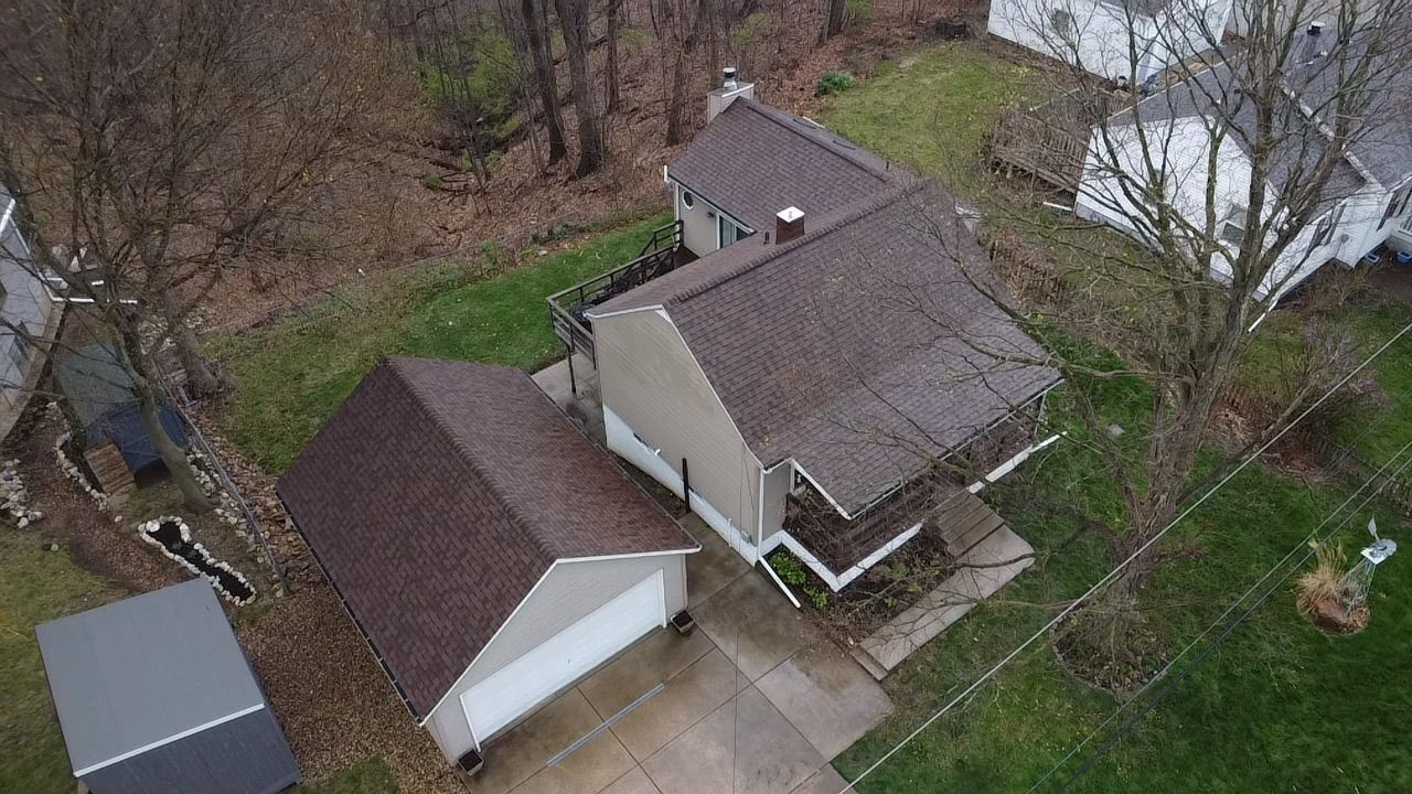 An aerial view of a house with a garage and a driveway.