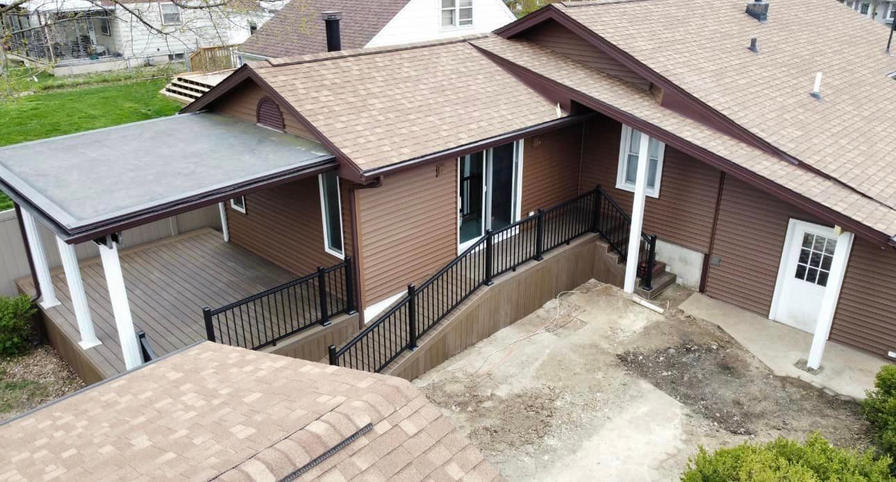 An aerial view of a house with a porch and stairs.