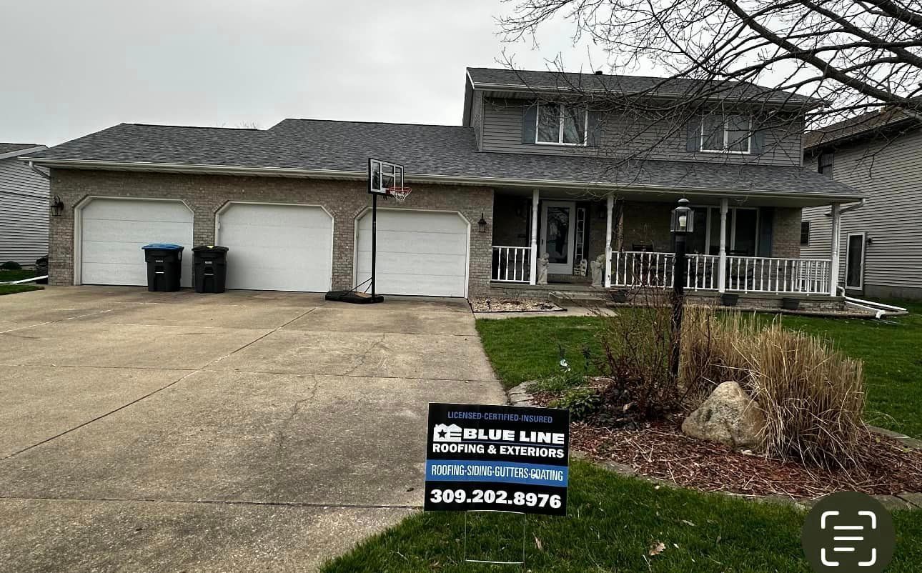 A house with a for sale sign in front of it