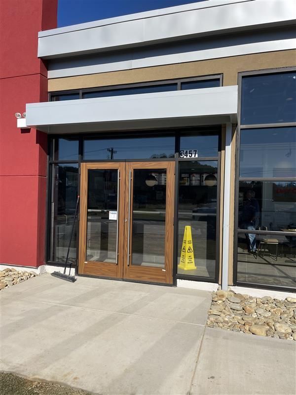 Double glass doors with brown frames; a yellow