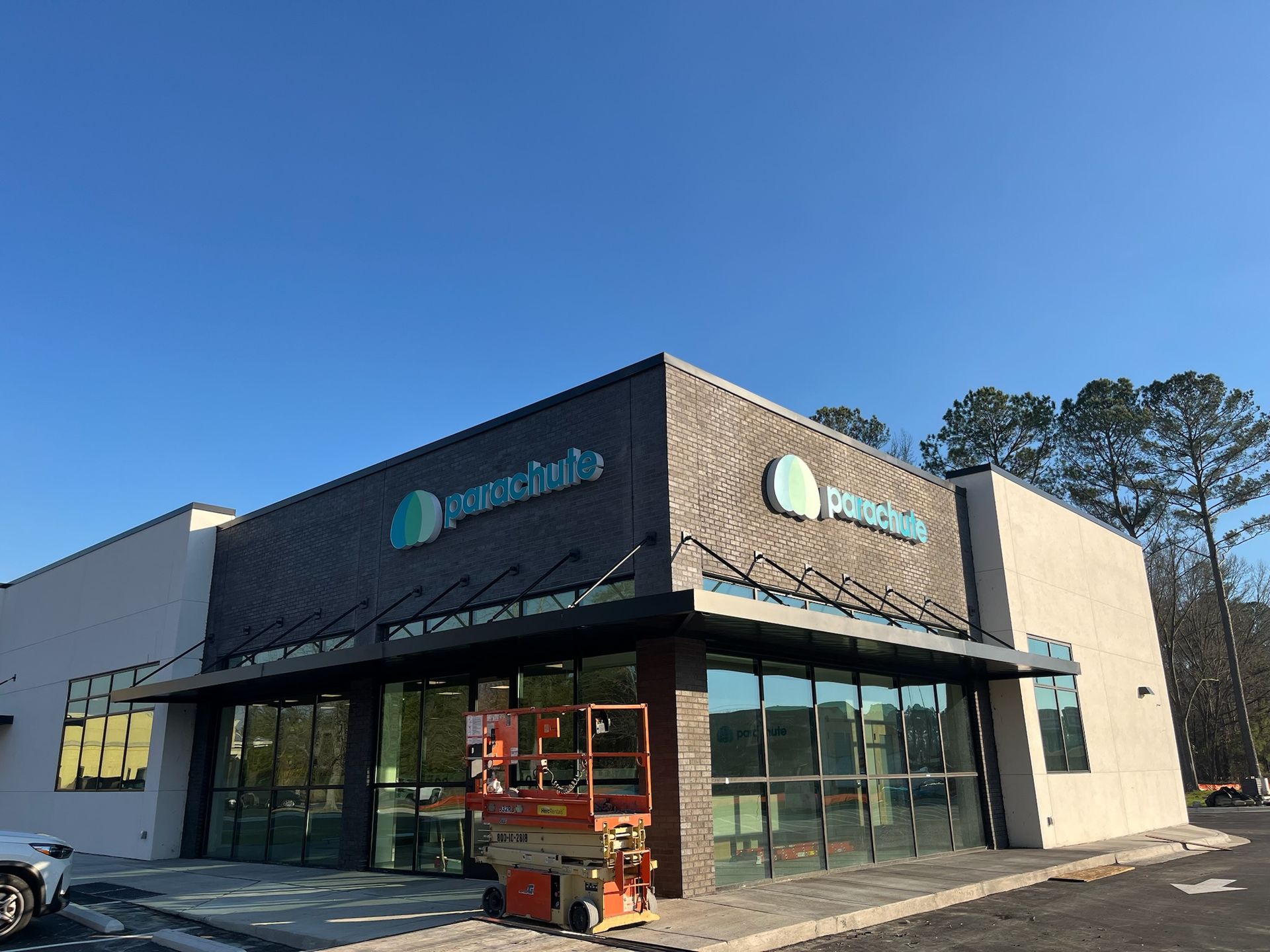 Exterior of a Panera Bread restaurant with signage, windows, and awning; blue sky overhead.