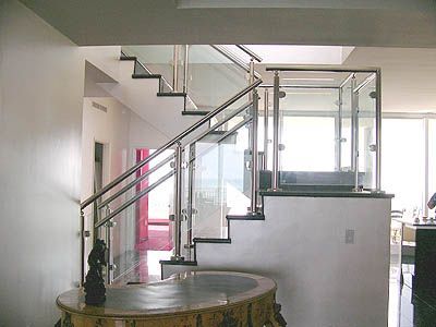 A staircase with a glass railing in a house