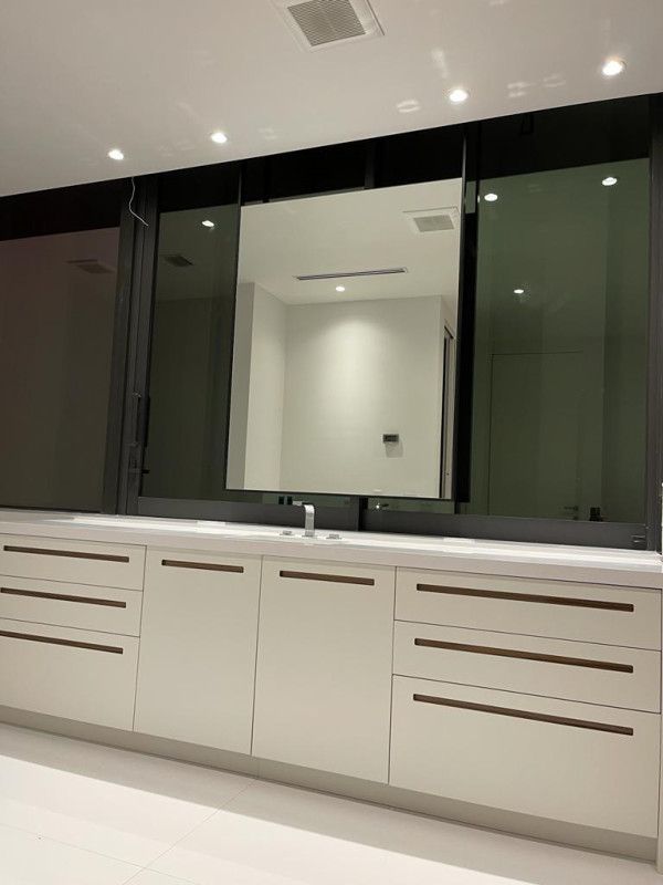 A bathroom with two sinks and a large mirror