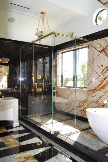 A bathroom with marble walls and a bathtub