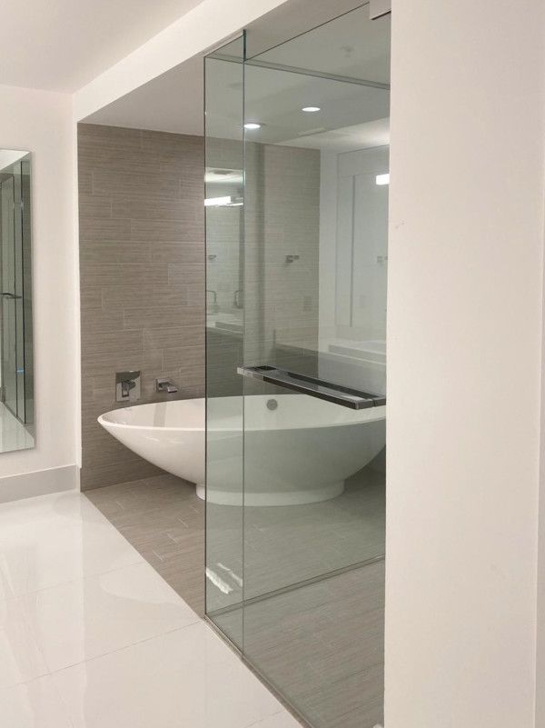 A bathroom with a bathtub and a walk in shower