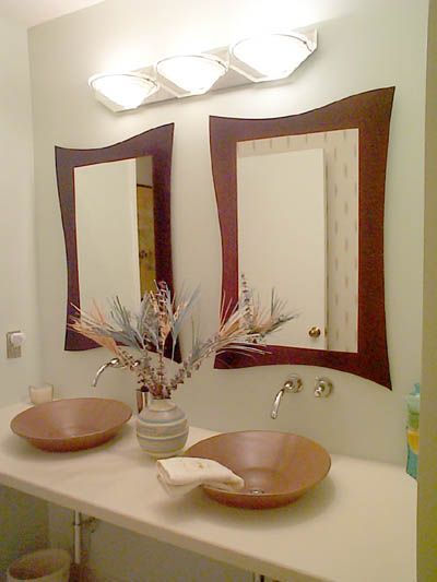 A bathroom with two sinks and two mirrors