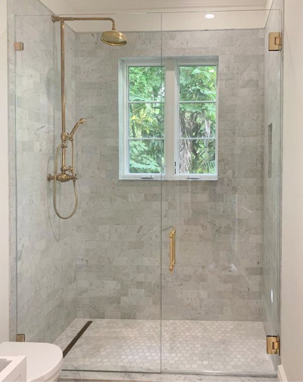 A bathroom with a walk in shower and a toilet