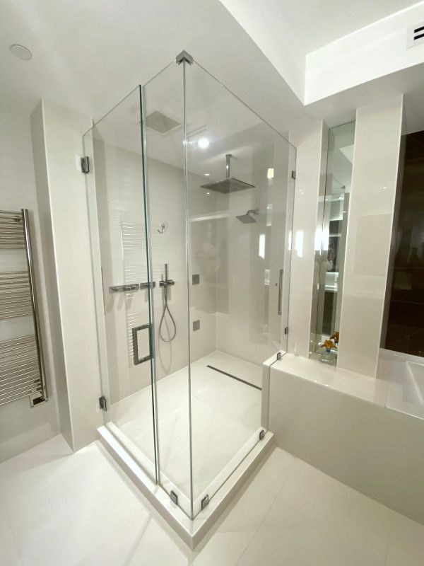 A bathroom with a walk in shower and a bathtub.