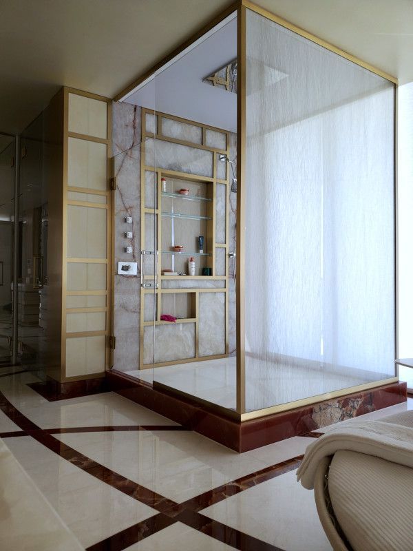 A bathroom with a walk in shower and a marble floor