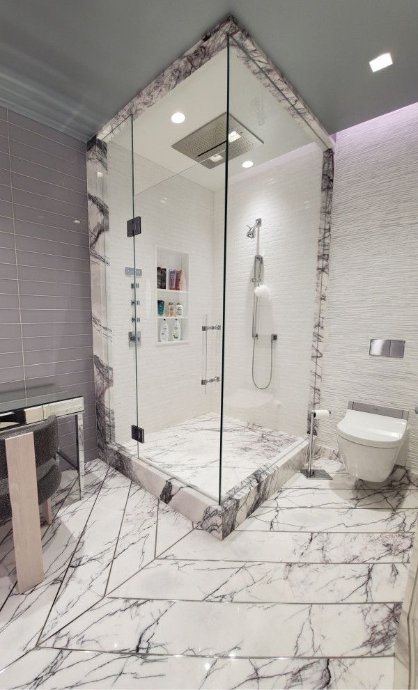 A bathroom with a walk in shower and a toilet.
