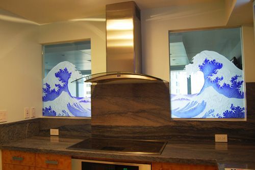A kitchen with a stove top oven and a stainless steel hood