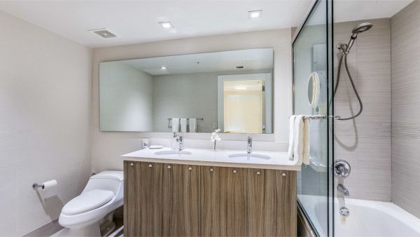 A bathroom with a toilet , sink , shower and bathtub.